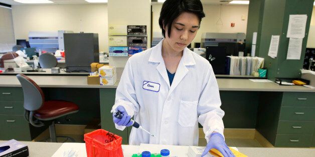 In this Feb. 27, 2015 photo, Choon Kambara, a forensic scientist in the Washington State Patrol's  crime lab in Seattle, demonstrates how DNA is extracted from mouth swabs and other collection methods. A bill that has passed the Washington state House and is awaiting action in the Senate would require DNA collected in any felony case charged as a violent or sex offense to be preserved through the length of the offender's sentence, including post-prison community custody. (AP Photo/Ted S. Warren)
