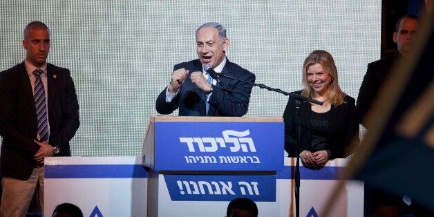 Israeli Prime Minister Benjamin Netanyahu greets supporters at the party's election headquarters In Tel Aviv. Wednesday, March 18, 2015. Exit polls from Israelâs national elections showed Prime Minister Benjamin Netanyahuâs Likud party nearly deadlocked with Isaac Herzogâs center-left Zionist Union. (AP Photo/Dan Balilty)