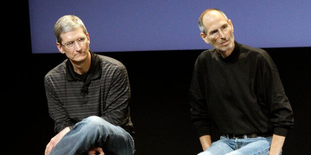 FILE - This July 16, 2010 photo shows Apple's Tim Cook, left, and Steve Jobs, right, during a meeting at Apple in Cupertino, Calif. Appleâs potential purchase of headphone maker Beats Electronics for $3.2 billion is just the latest example of how much Cook has deviated from Jobs, who had so much confidence in his companyâs innovative powers that he saw little sense in spending a lot of money on acquisitions. (AP Photo/Paul Sakuma, File)