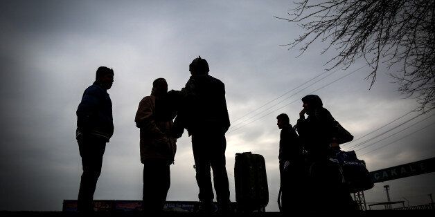 People are seen at the Akcakale border gate in Turkey, Saturday, Jan. 31, 2015, as some others wait for the possible release of Japanese journalist Kenji Goto, kidnapped by the Islamist militant group in Syria. The fates of a Japanese journalist and Jordanian military pilot were unknown Friday, a day after the latest purported deadline for a possible prisoner swap passed with no further word from the Islamic State group holding them captive.(AP Photo/Emrah Gurel)