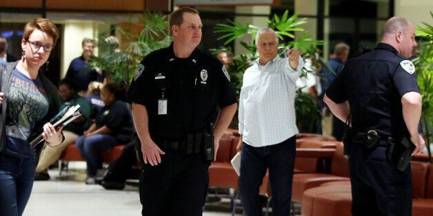 Officers guard the entrance to concourse A and B at the New Orleans International Airport, Friday, March 20, 2015, in Kenner, La. Richard White sprayed a TSA agent in the face with wasp killer then slashed a second guard with a machete before a third agent shot him three times at a security checkpoint in the New Orleans international airport Friday. (AP Photos/Jonathan Bachman)