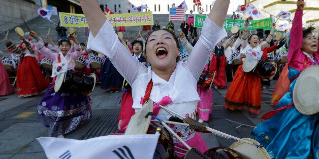 South Korean Christian women perform during a gathering to pray for the speedy recovery of U.S. Ambassador to South Korea Mark Lippert, near the U.S. embassy in Seoul, South Korea, Saturday, March 7, 2015.  Police on Friday investigated the motive of the anti-U.S. activist they say slashed the U.S. ambassador to South Korea, as questions turned to whether security was neglected. (AP Photo/Ahn Young-joon)