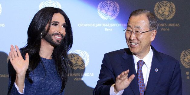 Austrian singer and Eurovision Song Contest winner Conchita Wurst and U.N. Secretary-General Ban Ki-moon, right, wave after Wurst's  performance during the Secretary-General's visit to the United Nations in Vienna at the International Center in Vienna, Austria, Monday, Nov. 3, 2014. (AP Photo/Ronald Zak)