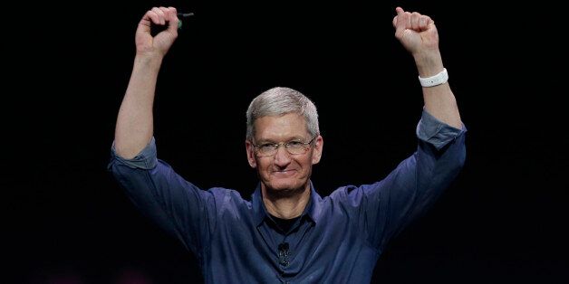 Apple CEO Tim Cook introduces Apple Watch , which he is wearing on his wrist, on Tuesday, Sept. 9, 2014, in Cupertino, Calif.  (AP Photo/Marcio Jose Sanchez)