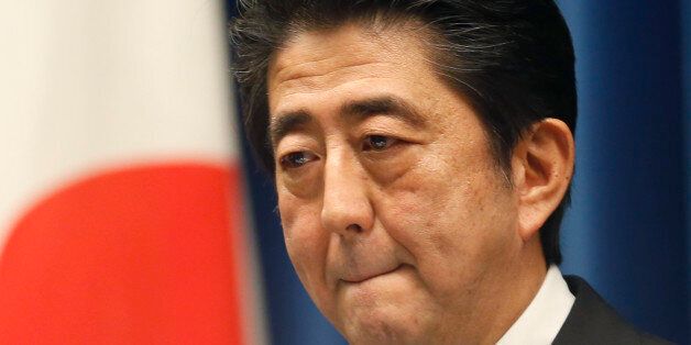Japan's Prime Minister Shinzo Abe reacts to a question during a press conference at his official residence in Tokyo, Tuesday, Nov. 18, 2014. Abe called a snap election for December and put off a sales tax hike planned for next year until 2017, vowing to step down if his strategy falls flat. (AP Photo/Shizuo Kambayashi)
