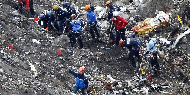Rescue workers work on debris of the Germanwings jet at the crash site near Seyne-les-Alpes, France, Thursday, March 26, 2015. The co-pilot of the Germanwings jet barricaded himself in the cockpit and âintentionallyâ rammed the plane full speed into the French Alps, ignoring the captainâs frantic pounding on the cockpit door and the screams of terror from passengers, a prosecutor said Thursday. In a split second, he killed all 150 people aboard the plane. (AP Photo/Laurent Ciprian