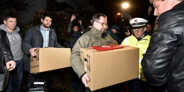 Investigators carry boxes from the apartment of Germanwings airliner jet co-pilot Andreas Lubitz, in Duesseldorf, Germany, Thursday March 26, 2015. On Thursday, French prosecutors said Lubitz, the co-pilot of Germanwings Flight 9525,