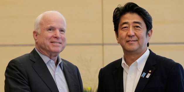 U.S. Sen. John McCain of Arizona, left, is greeted by Japanese Prime Minister Shinzo Abe prior to their meeting at the prime minister's official residence in Tokyo Wednesday, Aug. 21, 2013. (AP Photo/Itsuo Inouye, Pool)
