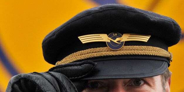 FILE - In this Feb. 22, 2010 file picture, a Lufthansa Airlines pilot holds the brim of his cap at the airport in Frankfurt, Germany. Carsten Spohr, CEO Lufthansa _ the parent company of Germanwings _ says his pilots undergo yearly medical examination but that doesn't include psychological tests. (AP Photo/dpa, Boris Roessler, File)