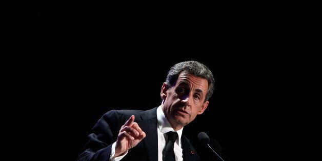 Former French President and conservative party UMP leader Nicolas Sarkozy gives a speech during a meeting in Asnieres, France, Tuesday March 24, 2015. The top two parties in weekend local elections were the conservative UMP and the far right National Front. (AP Photo/Thibault Camus)