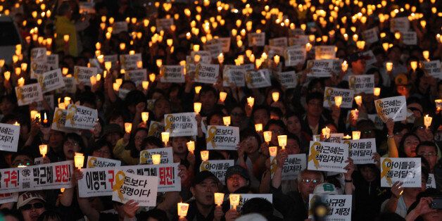People shout slogans during a rally to demand the government to seek the truth in poor handling of the sinking of the ferry Sewol, in Seoul, South Korea, Saturday, May 17, 2014. The sinking, one of the deadliest disasters in South Korean history, has triggered an outpouring of national grief.  The placards read