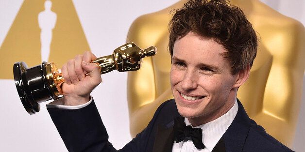 Eddie Redmayne poses in the press room with the award for best actor in a leading role for