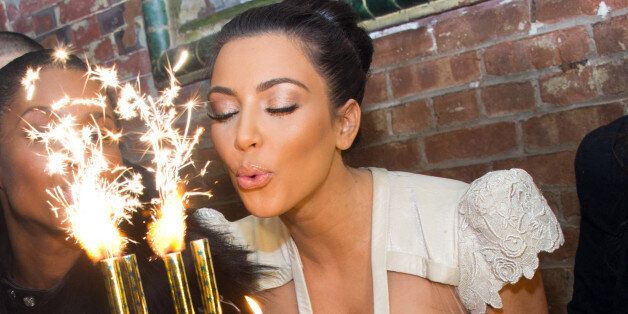 Kim Kardashian blows out the candles on a cake in celebration of her 30th Birthday at the 10th Anniversary of TAO restaurant in New York, early Sunday, Oct. 17, 2010. (AP Photo/Charles Sykes)