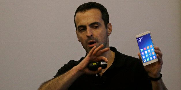 Xiaomi vice president of global operations Hugo Barra holds up a Mi Note during a presentation in San Francisco, Thursday, Feb. 12, 2015. While stopping short of declaring plans to sell phones in the United States, Xiaomi said Thursday that it will dip its toes in the U.S. market by selling headphones and other accessories online, through an Internet-based, fan-friendly model that has helped make the company one of the leading smartphone suppliers in China. (AP Photo/Jeff Chiu)