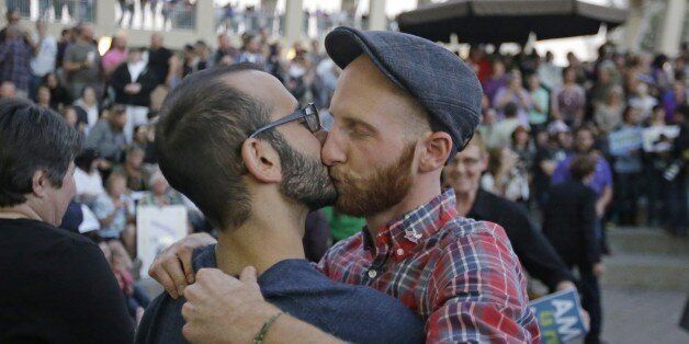 FILE - In this Monday, Oct. 6, 2014, file photo, plaintiffs, Moudi Sbeity, left, and his partner Derek Kitchen kiss during a gay marriage rally, in Salt Lake City. The U.S. Supreme Court's decision not to take an appeal of Utah's gay marriage case means that a parallel lawsuit brought by gay and lesbian couples who sued the state over its decision not to recognize their marriages has been resolved too. (AP Photo/Rick Bowmer, File)