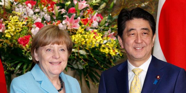 German Chancellor Angela Merkel and Japanese Prime Minister Shinzo Abe pose for photographers prior to a meeting at Abe's official residence in Tokyo, Monday, March 9, 2015. Merkel is on a two-day visit as part of a series of bilateral meetings with G-7 leaders ahead of a June summit in Germany. (AP Photo/Shizuo Kambayashi, Pool)