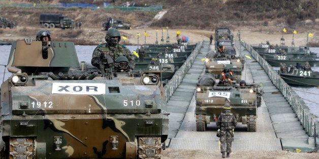 South Korean armored army vehicles cross a floating bridge on the Nam Han River during an annual military exercise in Yeoju, South Korea, Wednesday, Nov. 12, 2014. The drill is part of the annual