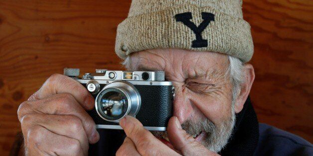 An amateur photographer, oysterman Alan Sterling demonstrates his beloved vintage Leica camera aboard his homemade boat Gloria in Westport, Conn. Wednesday, Nov. 19, 2008. Sterling found the camera in an antique shop in nearby Fairfield and used it to take pictures of his recently departed partner Gloria, after whom his fishing boat is named. (AP Photo/Kathy Willens)