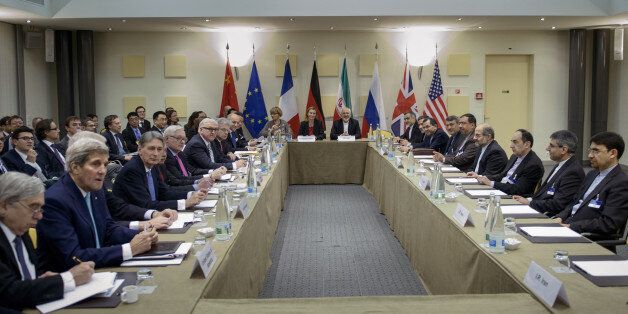 Iranian Foreign Minister Javad Zarif, center right, European Union High Representative Federica Mogherini, center left, and other officials from Britain, China, France, Germany, Russia and the United States wait for the start of a meeting on Iran's nuclear program at the Beau Rivage Palace Hotel in Lausanne, Switzerland Tuesday, March 31, 2015. Diplomats scrambled Tuesday to reach consensus on the outline of an Iran nuclear deal just hwait for the start of a meeting on Iran's nuclear program ours ahead of a self-imposed deadline to produce an agreement. (AP Photo/Brendan Smialowski, Pool)