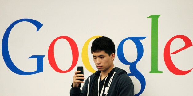 A man uses a cellphone during a seminar for small businesses at Google offices, Oct. 17, 2012 in New York. (AP Photo/Mark Lennihan)