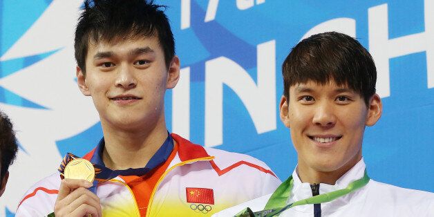 Gold medalist China's Sun Yang, centre, stands on the podium with silver medalist Japan's Kosuke Hagino, left, and bronze medalist South Korea's Park Tae-whan after winning the men's 400-meter freestyle final at the 17th Asian Games in Incheon, South Korea,  Tuesday, Sept. 23, 2014.(AP Photo/Rob Griffith)
