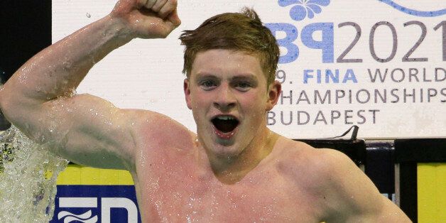 CORRECTS TO SEMIFINAL - Britain's Adam Peaty celebrates setting a new world record as he wins his men's 50m breaststroke senifinal at the LEN Swimming European Championships in Berlin, Germany, Friday, Aug. 22, 2014. (AP Photo/Gero Breloer)