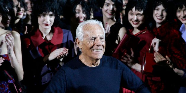 Italian fashion designer Giorgio Armani poses with his models after presenting the Emporio Armani women's Fall-Winter 2015-2016 collection, part of the Milan Fashion Week, unveiled in Milan, Italy, Friday, Feb. 27, 2015. (AP Photo/Antonio Calanni)