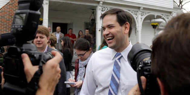 Republican presidential candidate, Sen. Marco Rubio, R-Fla., laughs as he is surrounded by media at a campaign house party, Friday, April 17, 2015, in Manchester, N.H. (AP Photo/Elise Amendola)