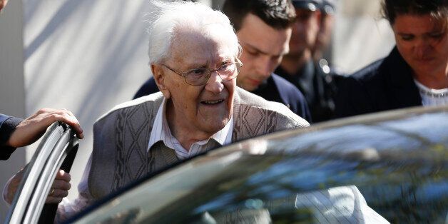 Former SS guard Oskar Groening enters a car after the first day of the trial against him in Lueneburg, northern Germany, Tuesday, April 21, 2015. The 93-year-old former Auschwitz guard faces trial on 300,000 counts of accessory to murder, in a case that will test the argument that anyone who served at a Nazi death camp was complicit in what happened there. (AP Photo/Markus Schreiber)