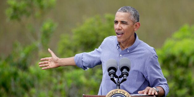 President Barack Obama gestures while making remarks after touring Everglades National Park on Earth Day, Wednesday, April 22, 2015, in Florida. Obama used the visit  to warn of the damage that climate change is already inflicting on the nation's environmental treasures. (AP Photo/Lynne Sladky)