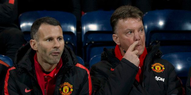 Manchester United's manager Louis van Gaal, right, takes his seat next to assistant manager Ryan Giggs before the English FA Cup Fifth Round soccer match between Preston and Manchester United at Deepdale Stadium in Preston, England, Monday Feb. 16, 2015.  (AP Photo/Jon Super)