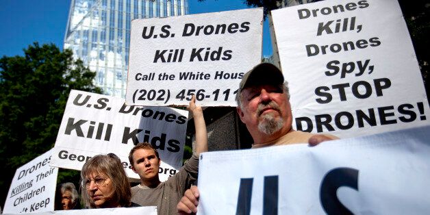 Demonstrators protest against the use of drones outside the International Conference on Unmanned Aircraft Systems at the Grand Hyatt Hotel, Tuesday, May 28, 2013, in Atlanta. Conference organizers say the gathering allows representatives from academia, industry and government to discuss expansion of unmanned aerial vehicles commonly called drones. (AP Photo/David Goldman)