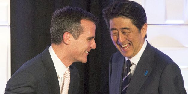 Los Angeles mayor Eric Garcetti, left, and Japanese Prime Minister Shinzo Abe share a laugh at the Investment Seminar reception at the Millennium Biltmore hotel in Los Angeles Friday, May 1, 2015. (David McNew/Pool via AP)