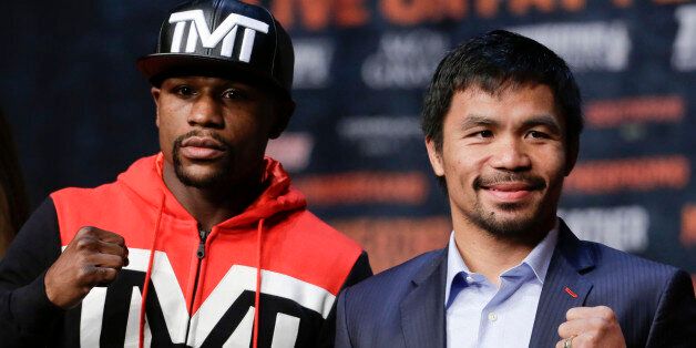 Boxers Floyd Mayweather Jr., left, and Manny Pacquiao pose for photographers during a press conference Wednesday, April 29, 2015, in Las Vegas. The pair are slated to square off Saturday in Las Vegas. (AP Photo/Chris Carlson)