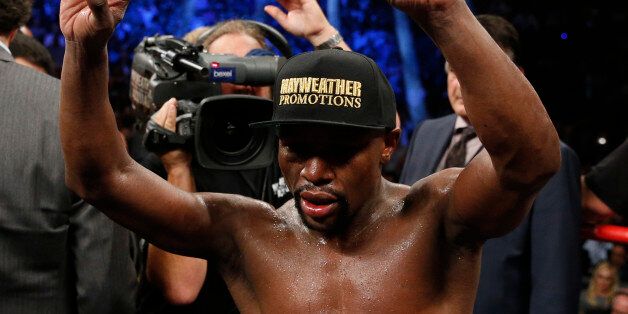 Floyd Mayweather Jr. celebrates after his welterweight title fight against Manny Pacquiao, from the Philippines, on Saturday, May 2, 2015 in Las Vegas.(AP Photo/John Locher)
