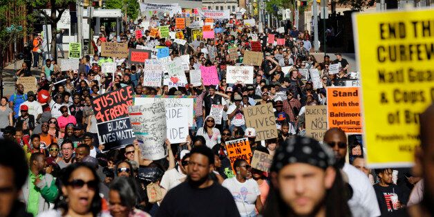 Protesters march through Baltimore on Saturday, May 2, 2015, the day after charges were announced against the police officers involved in Freddie Gray's death. (AP Photo/Patrick Semansky)