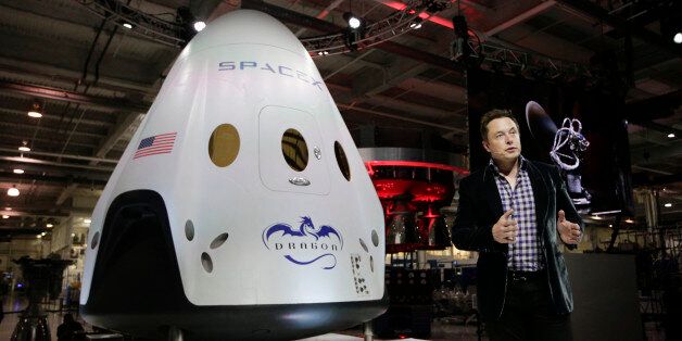 In this May 29, 2014 photo, Elon Musk, CEO and CTO of SpaceX, introduces the SpaceX Dragon V2 spaceship at the SpaceX headquarters in Hawthorne, Calif. On Tuesday, Sept. 16, 2014, NASA will announce which one or two private companies wins the right to transport astronauts to the International Space Station. The deal will end NASA's expensive reliance on Russian crew transport. The contenders include SpaceX, Sierra Nevada Corp., and Boeing. (AP Photo/Jae C. Hong, file)