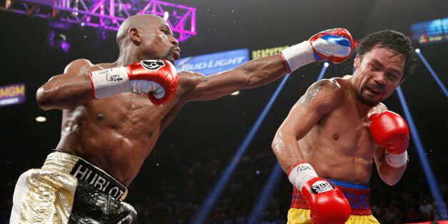 FILE - In this May 2, 2015 file photo, Floyd Mayweather Jr., left, hits Manny Pacquiao, from the Philippines, during their welterweight title fight in Las Vegas. The broadcast of fight was marred by technical snafus and got sucker punched by Internet streamers, exposing the industryâs vulnerabilities. (AP Photo/John Locher, File)