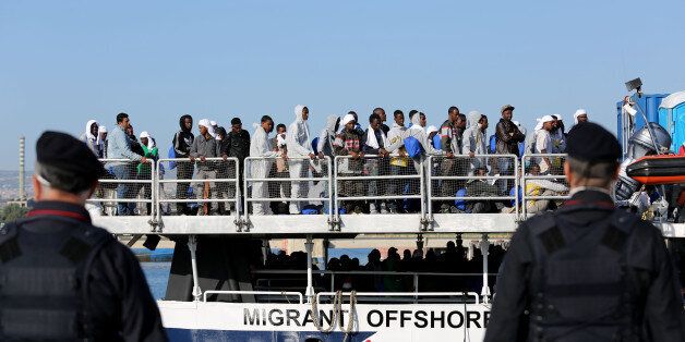Migrants wait to disembark from the Migrant Offshore Aid Station vessel ' Phoenix ' in the harbor of Augusta, Sicily, Southern Italy, Saturday, May 9, 2015. European Union plans to introduce a quota system obliging countries to share the burden of settling refugees unraveled Friday as member nations began rejecting the scheme. (AP Photo/Francesco Malavolta)