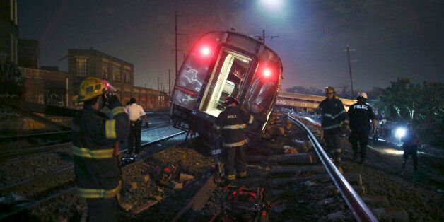 Emergency personnel work the scene of a deadly train wreck, Tuesday, May 12, 2015, in Philadelphia. An Amtrak train headed to New York City derailed and tipped over in Philadelphia. (AP Photo/ Joseph Kaczmarek)