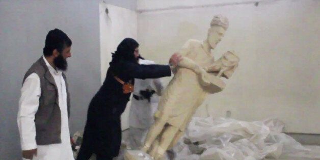 FILE - In this image made from video posted on a social media account affiliated with the Islamic State group on Thursday, Feb. 26, 2015, which has been verified and is consistent with other AP reporting, a militant topples an ancient artifact in the Ninevah Museum in Mosul, Iraq. Islamic State militants have looted and vandalized the museum in Mosul, Iraqâs 2nd largest city, and have massively damaged the ancient cities of Hatra and Ninevah both UNESCO world heritage sites. (AP Photo via m
