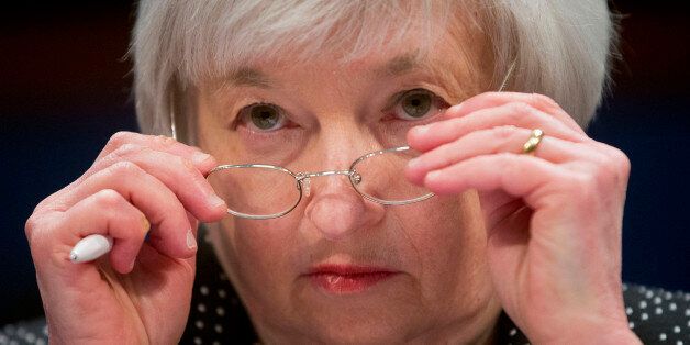 Federal Reserve Chair Janet Yellen removes her glasses as she testifies on Capitol Hill in Washington, Wednesday, Feb. 25, 2015, before the House Financial Services Committee hearing:
