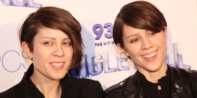 Tegan Quin (left) and Sara Quin of Tegan and Sara walk the red carpet at the 93.3 FLZ Jingle Ball at the Tampa Bay Times Forum on Wednesday December 18, 2013 in Tampa Florida.(Photo by John Davisson/Invision/AP)
