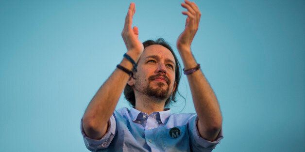 Pablo Iglesias, the leader of Spain's new and growing left wing 'Podemos' (We Can) party, salutes the crowd during a meeting with supporters for the upcoming local elections in Madrid, Spain, Friday, May 22, 2015. Spain could be set for a political upheaval in key local elections this weekend, with strong signs that voters fed up with economic crisis and corruption scandals may punish both the ruling conservative Popular Party and the leading opposition Socialists. (AP Photo/Andres Kudacki)