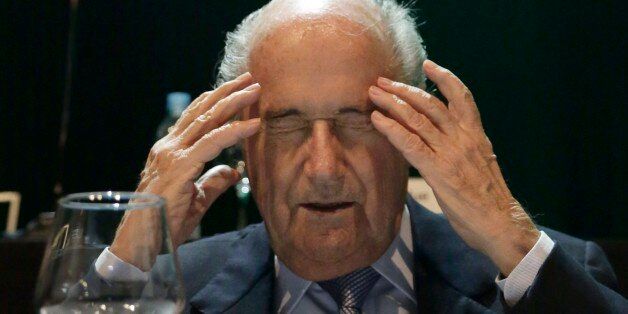 In this Wednesday, March 4, 2015 photo, FIFA President Sepp Blatter closes his eyes as he raises his hands to his temples during a CONMEBOL congress in Asuncion, Paraguay. The 78-year-old Blatter is seeking a fifth, four-year term running football. (AP Photo/Jorge Saenz)