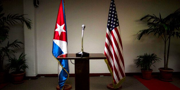 FILE - In this Jan. 22, 2015 file photo, a Cuban and U.S. flag stand before the start of a press conference on the sidelines of talks between the two nations in Havana, Cuba. The U.S. hopes to open an embassy in Havana before presidents Barack Obama and Raul Castro meet at a regional summit in April, which will be the scene of the presidentsâ first face-to-face meeting since they announced on Dec. 17 that they will re-establish diplomatic relations after a half-century of hostility. (AP Pho