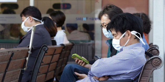 South Koreans wearing masks as a precaution against the Middle East Respiratory Syndrome virus sit at an emergency room at Seoul National University Hospital in Seoul, South Korea Monday, June 1, 2015. More than 680 people in South Korea are isolated after having contact with patients infected with a virus that has killed hundreds of people in the Middle East, health officials said Monday. (AP Photo/Ahn Young-joon)