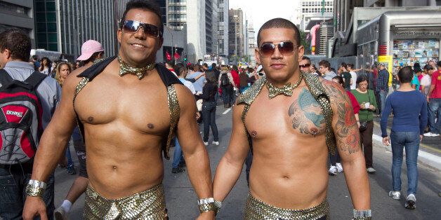 A couple participate in a Gay Pride Parade in Sao Paulo, Brazil, Sunday, June 10, 2012. (AP Photo/Andre Penner)