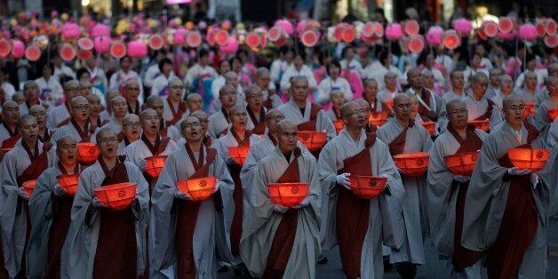 Buddhist monks carry lanterns in a parade during the Lotus Lantern Festival to celebrate the upcoming birthday of Buddha on May 28, on a street in Seoul, South Korea, Sunday, May 19, 2012. (AP Photo/Ahn Young-joon)