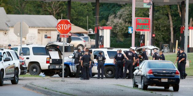 Police block the intersection of Dowdy Ferry Rd and Interstate 45 during a stand off with a gunman barricaded inside a van, Saturday, June 13, 2015, in Hutchins, Texas. The gunman allegedly attacked Dallas Police Headquarters. (AP Photo/Brandon Wade)